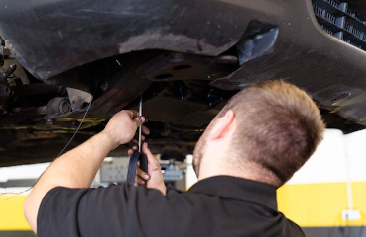 Mecànic de Rodi Motor Services treballant sota un cotxe al taller